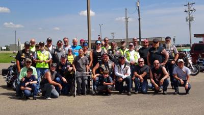 Jackie Rhode posing with Christian Motorcyclist Association chapter members.