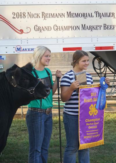 two young women showing their animal and awards