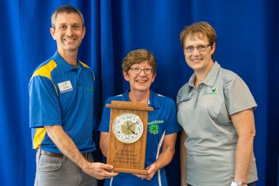 Joy Braun receiving a 2019 South Dakota 4-H Hall of Fame engraved clock.