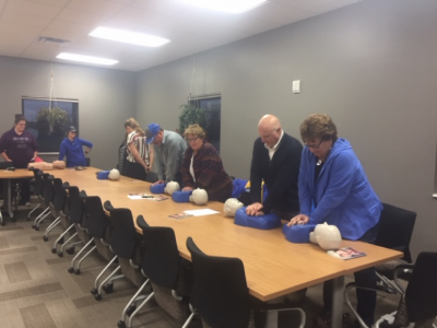 an image of several people practicing cardiopulmonary resuscitation training