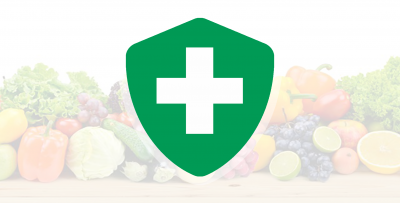 A green shield icon with a white cross in front of a variety of fruits and vegetables.