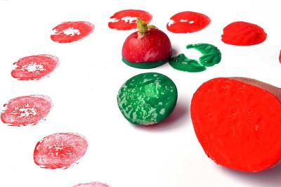 Chopped vegetables being used as stamps on construction paper.
