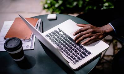 Young, african american male using laptop computer.