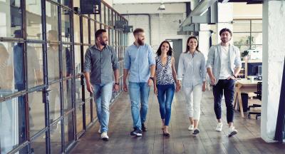 Diverse group of young professionals walking in an office.