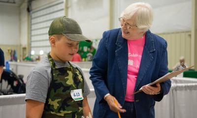 4-H volunteer talking to a 4-H youth.