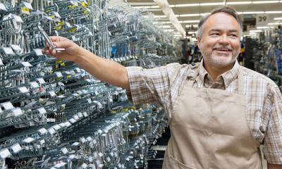 Hardware store owner assisting a customer.