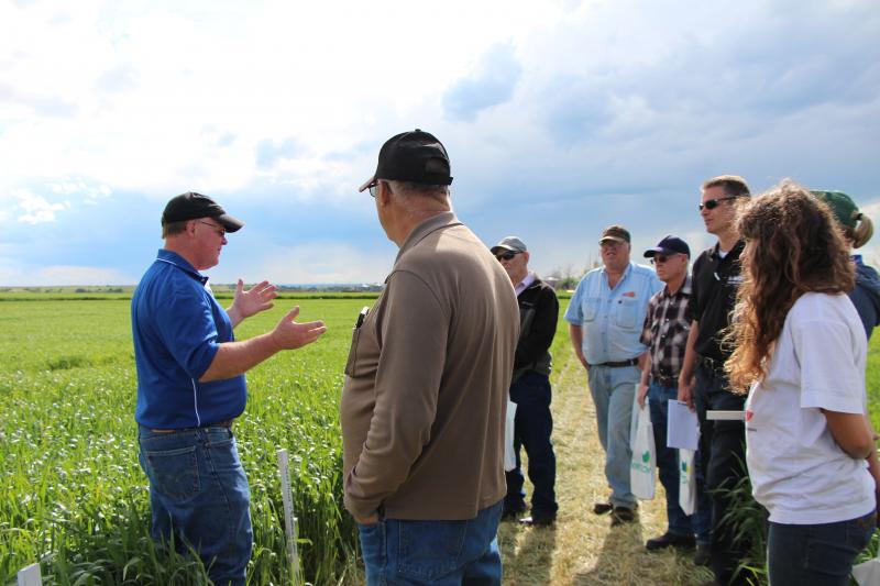 Anthony Bly presenting in front of a field