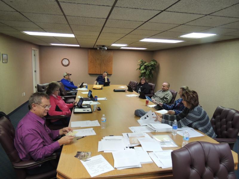 A group of people meeting at a conference table.