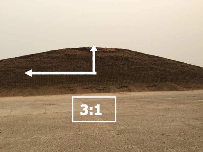 A silage pile with a white diagram on it demonstrating the proper slope. Call Tracey Erickson at 605.882.5140 for more information.