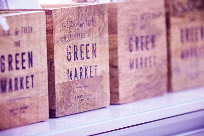 A row of CSA subscription boxes with the words Green Market printed on them.
