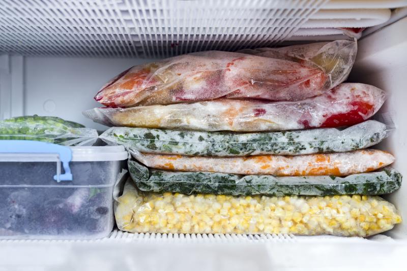 various meals packed in ziplock bags and stored in a freezer