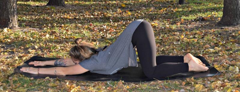 Young woman demonstrating extended puppy pose