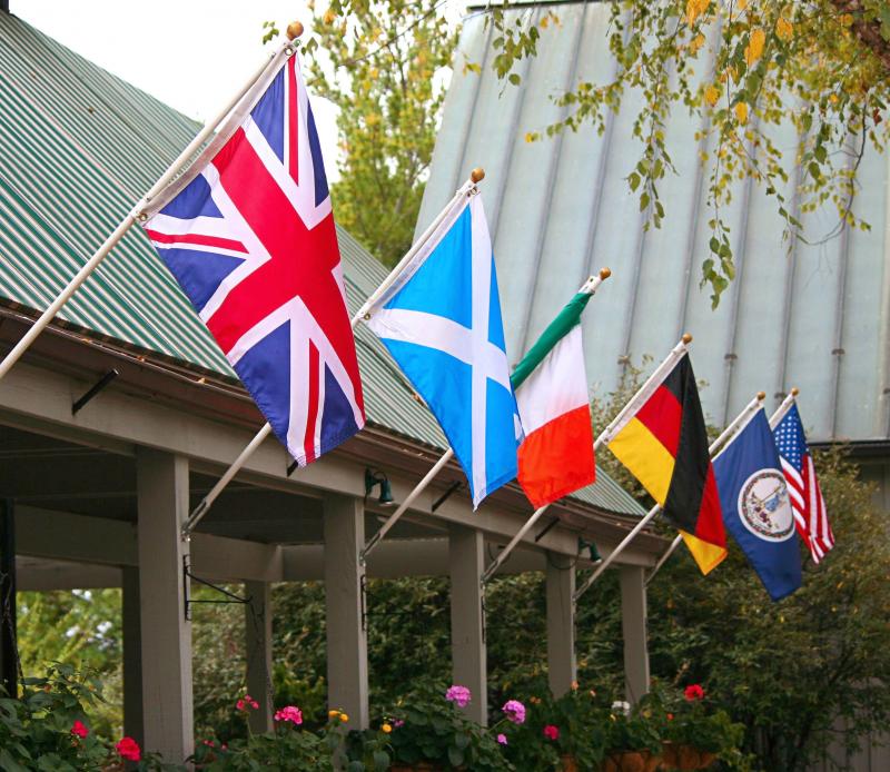 various international flags displayed at an outdoor pavilion