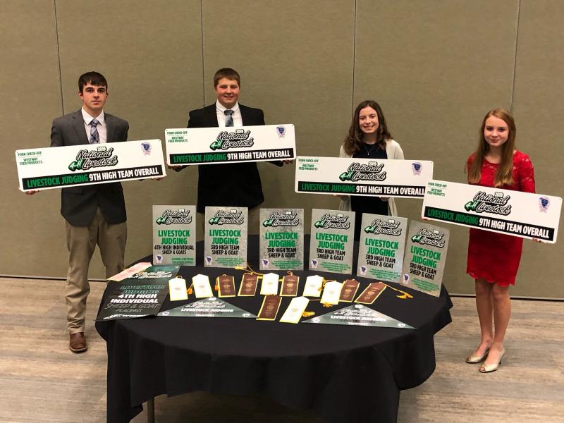 an image with several young people with awards they have won