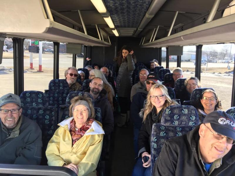 multiple people waiting on a bus