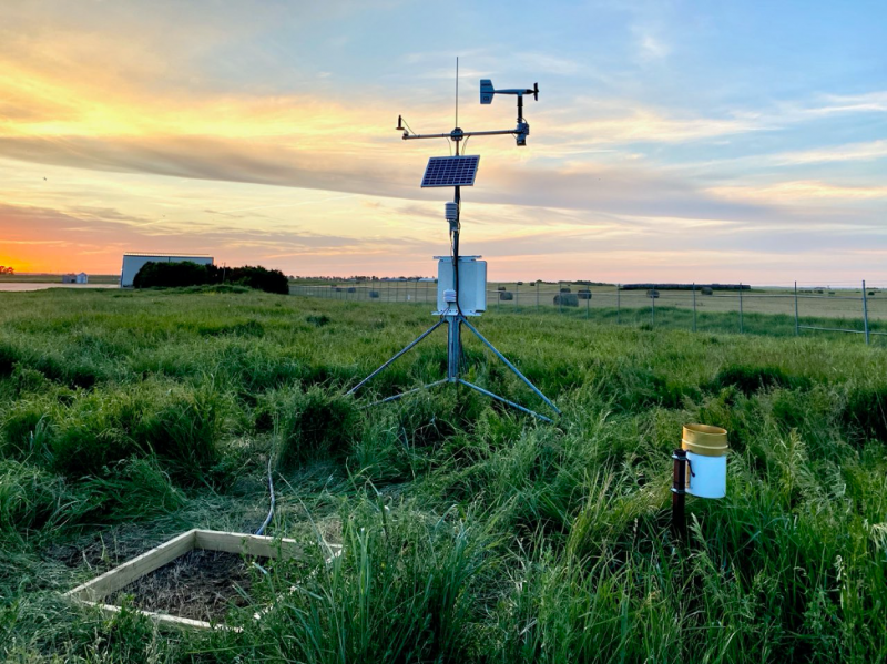 several pieces of weather monitoring equipment in a green field