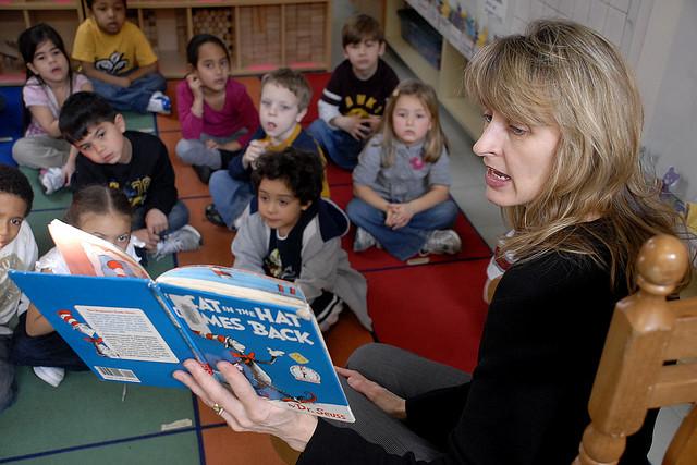 Teacher reads the Cat in the Hat to a class of young students