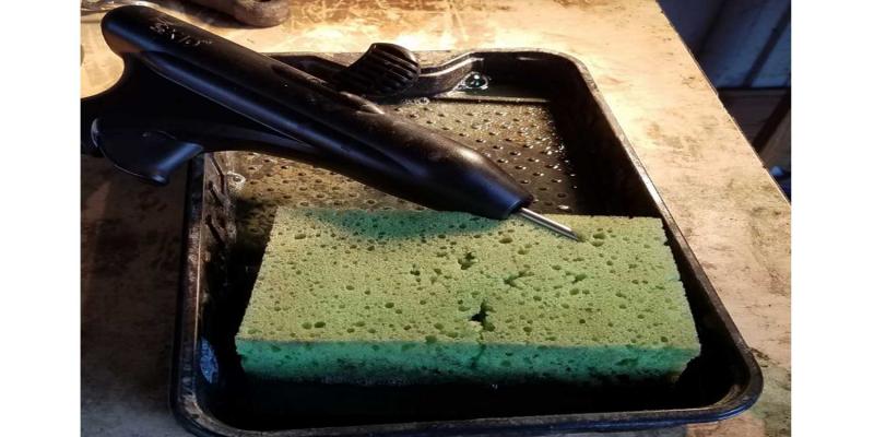 Implant gun, sponge and cleaning tray.
