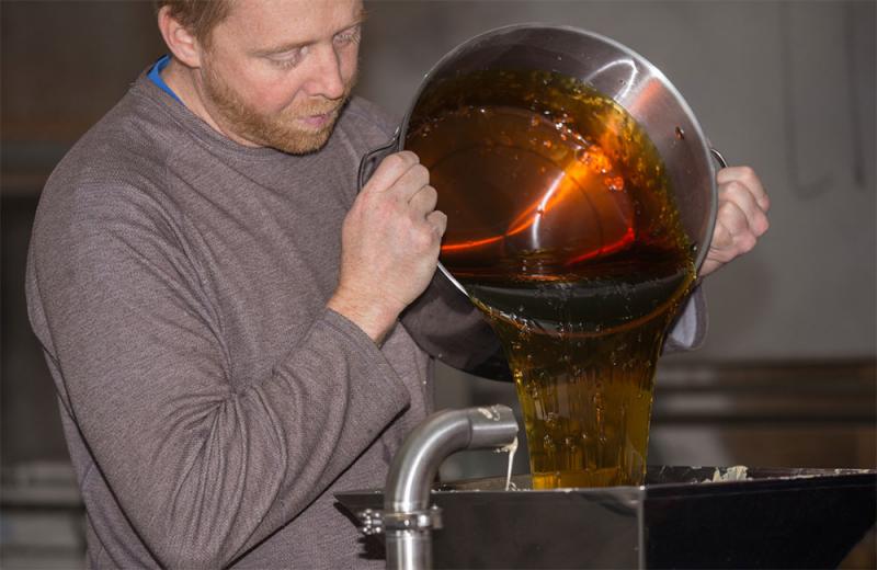 Adult male processing a batch of maple syrup.