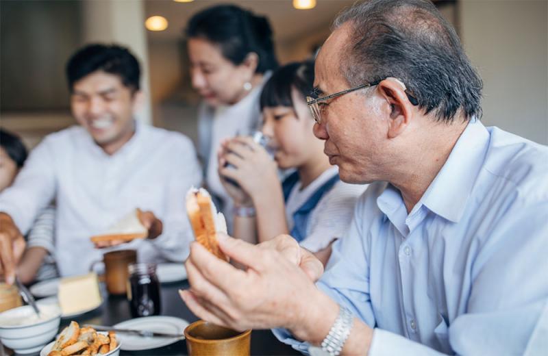 Asian family sharing a holiday meal together.