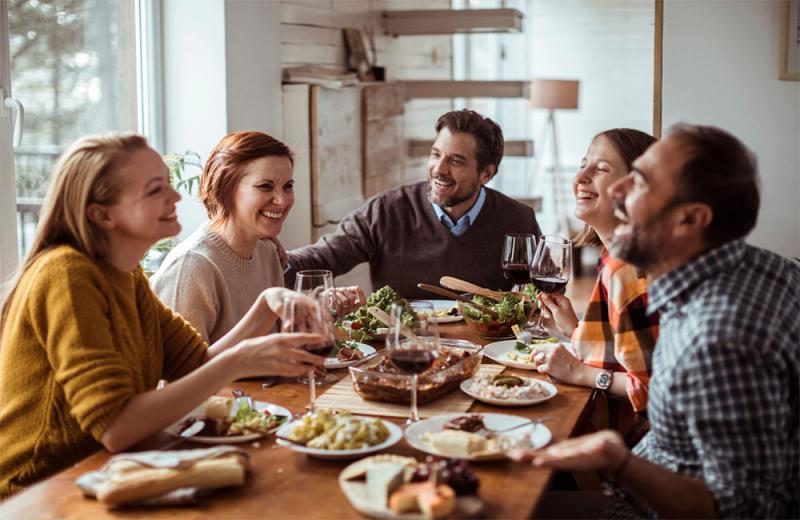 Group of family and friends sharing a holiday meal.