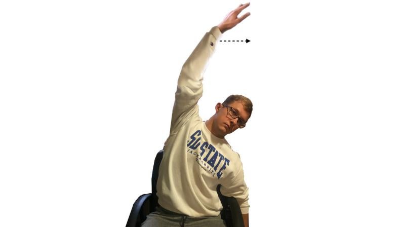 Young man demonstrating the seated side stretch. For a complete description, call SDSU Extension at 605-688-4792.