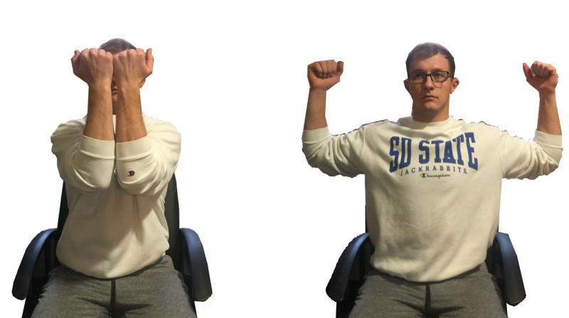 Young man demonstrating the goal posts stretch. For a complete description, call SDSU Extension at 605-688-4792.