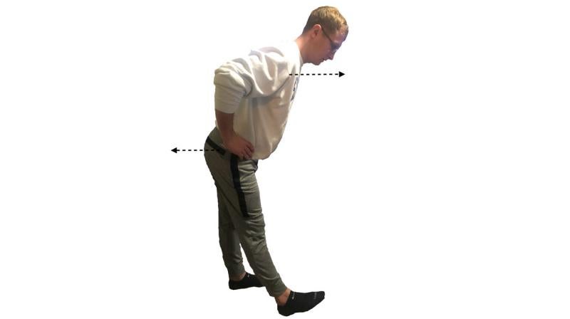 Young man demonstrating the standing hamstring stretch. For a complete description, call SDSU Extension at 605-688-4792.