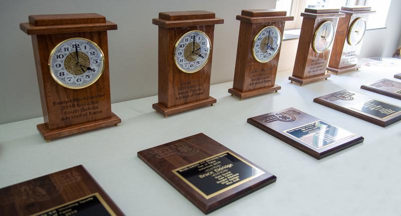 4-H Volunteer Hall of Fame Awards arranged on a table.