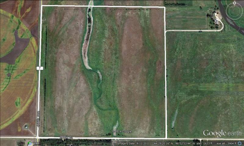 An aerial photograph of pastureland with an emerging cedar tree problem.