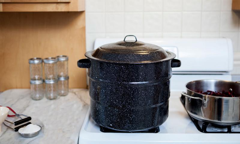 Canning supplies arranged on a kitchen counter.