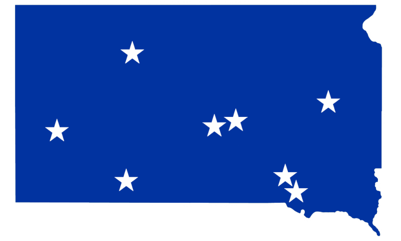 Blue map of South Dakota with white stars representing communities with active wellness coalitions, including: DeSmet, Dupree, Fort Thompson, Lower Brule, Lake Andes, Martin, Rapid City and Wagner.