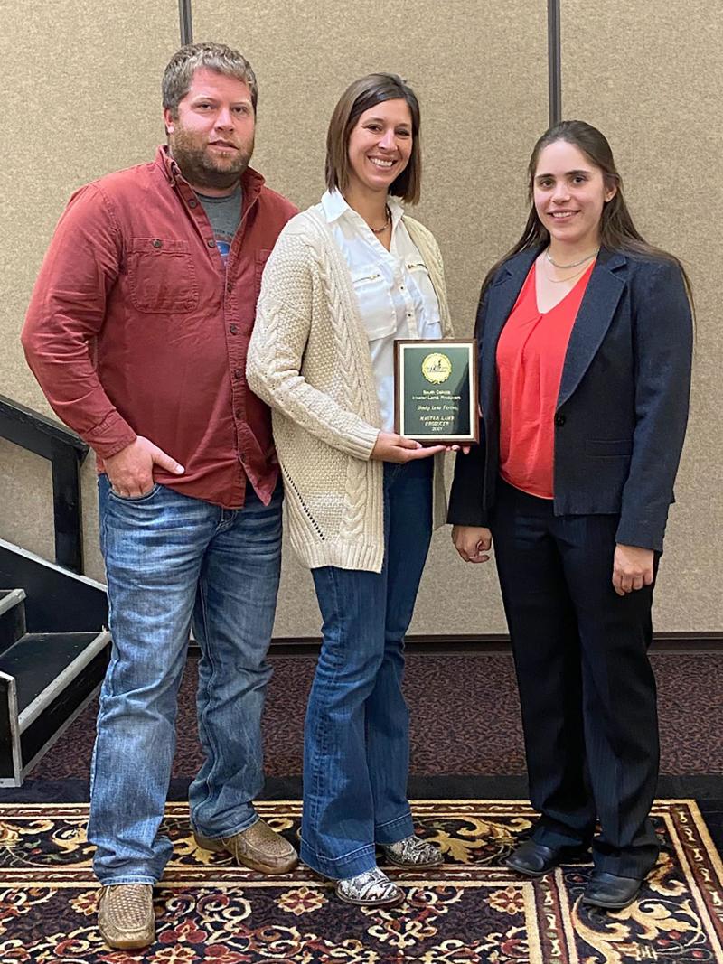 Chad and Nicole Jessen accepting their Purebred Division award from SDSU Extension's Kelly Froehlich.