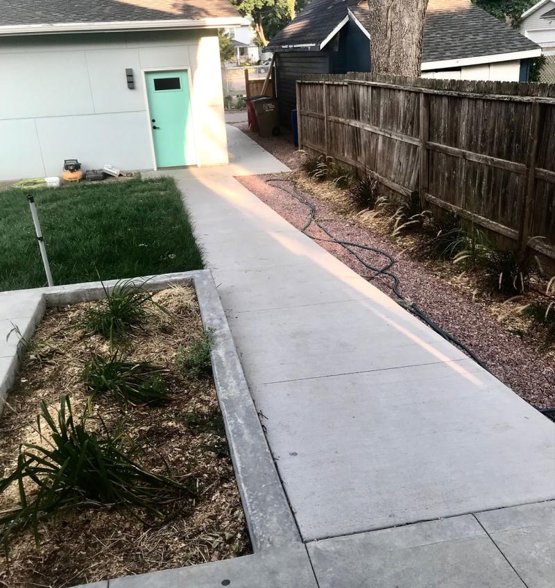 Rear, no-step entrance of a modern, adaptable home with a level walkway.