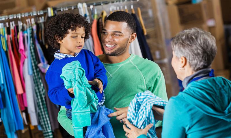Father and son accepting a coat at a community coat drive.