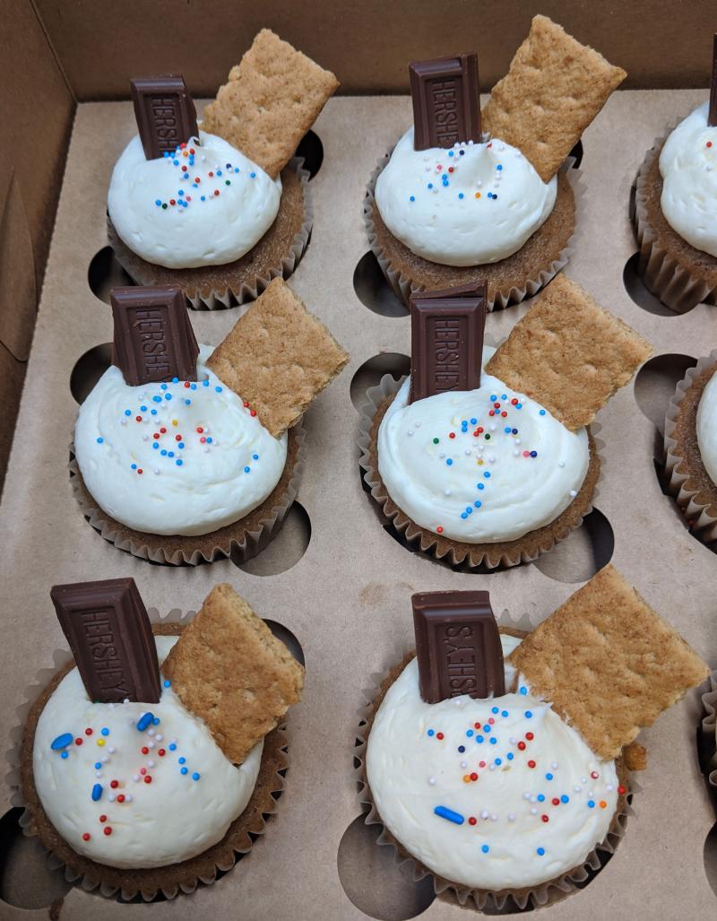Several s'mores cupcakes arranged in a baking tin.