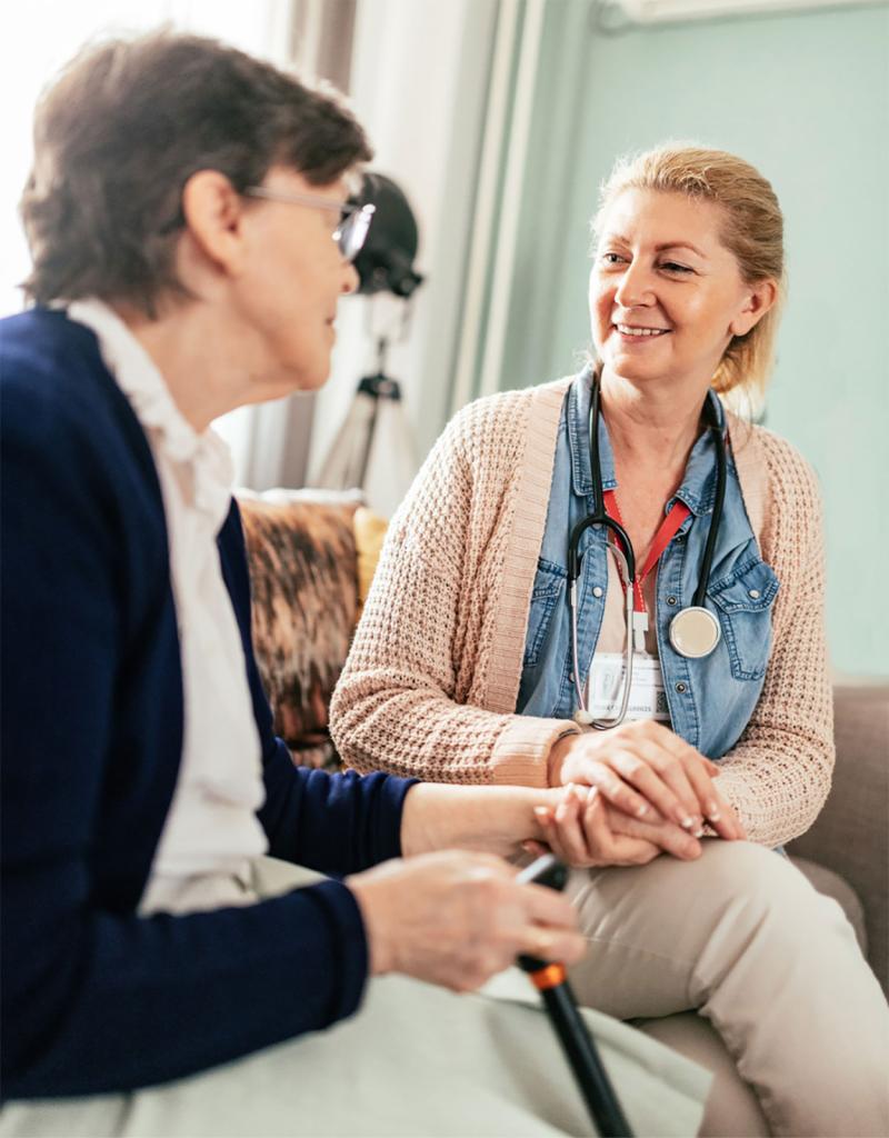 Home health care specialist visiting with an older female adult.