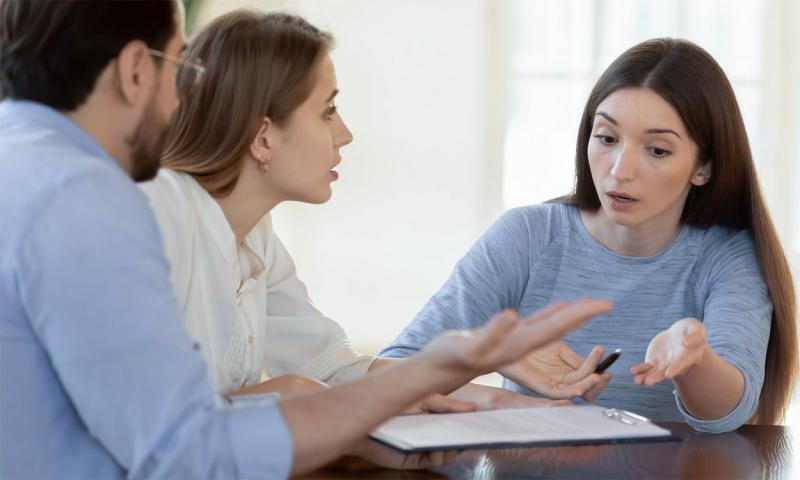 Young couple discussing a concern with a distressed small business team member.