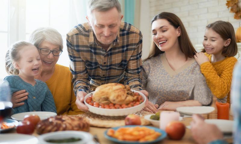 Family sharing a Thanksgiving meal.