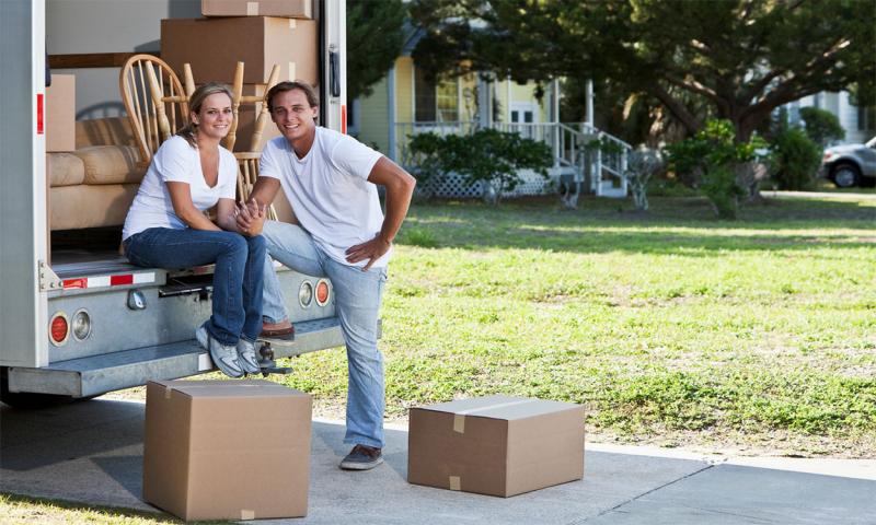 Young couple with moving truck.