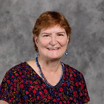 Professional headshot of Rhoda Burrows