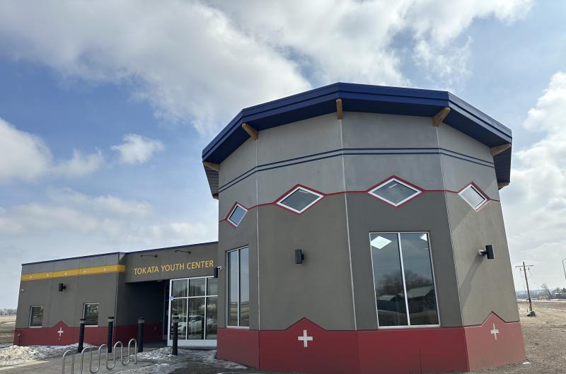 The Tokata Youth Center is pictured close up with blue sky and clouds in the background