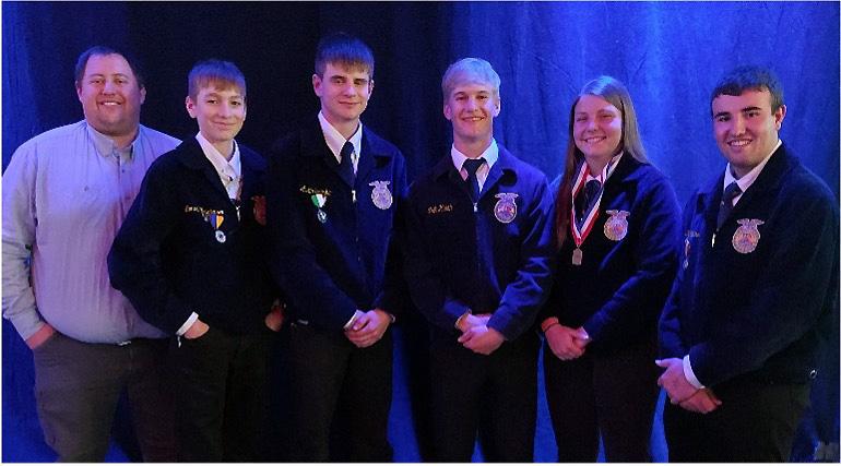 The Wessington Springs FFA Range Judging Team stands in front of a curtain.