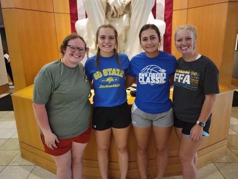 The McCook County 4-H Homesite Judging Team, Ava Sieverding, Karlie Stiefvater, Maddy Lauck, and Lauren Roling, stand in front of a statue