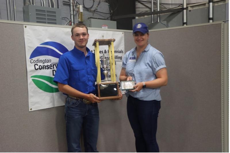 Caleb Weyh and SDSU Extension Range Specialist Krista Ehlert pose with Weyh's awards