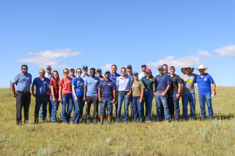 the members of the Cottonwood Research Field School stand in a group looking toward the camera