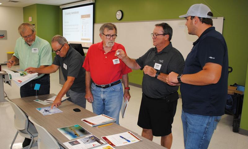 Workshop attendees at an aquatic species identification station.