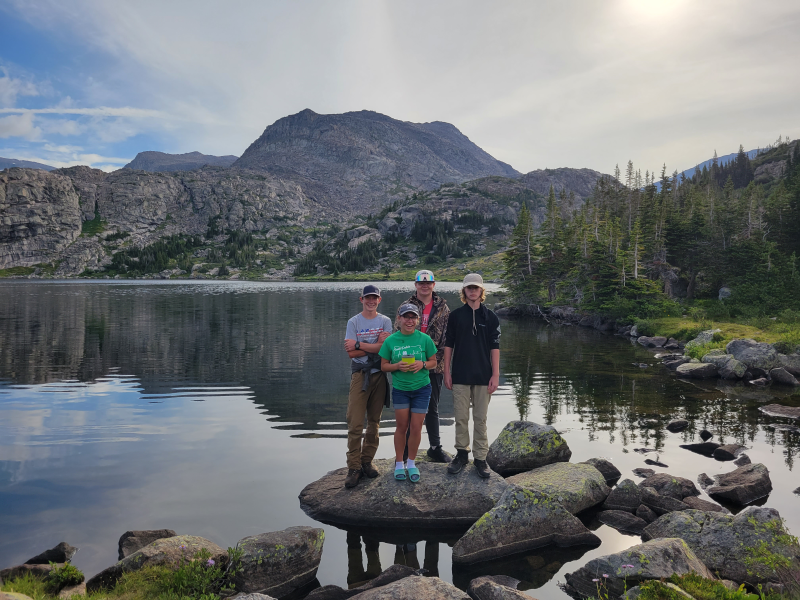 Group of youth standing in front of mountains