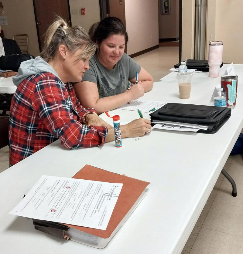 Participants Kari Feldhaus and Kelsy Hokana work together on an educational activity during Annie’s Project in Britton.