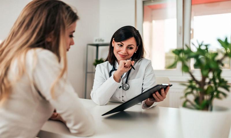 Doctor reviewing wellness exam results with a patient.
